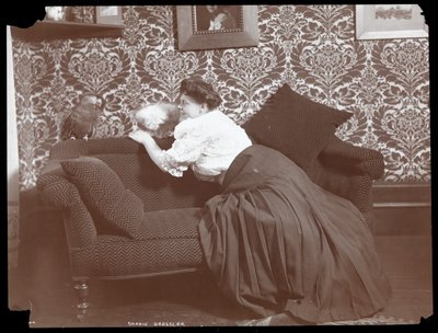 Marie Dressler at Home with Dog and Parrot, 1905 by Byron Company